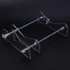 A clear acrylic bottle cutter with metal hardware against a black background. Anteprima dell’immagine prodotto