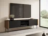A modern TV lowboard with a television mounted above it, in a well-lit room with a large window showing an outdoor scene. Náhled obrázku produktu