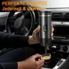A person is using a portable espresso machine in a car. Produktbild-Vorschau