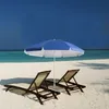 Two lounge chairs and a blue umbrella on a sandy beach with turquoise water and a dark blue sky. Produktbild-Vorschau