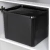A black storage bin with a lid sits inside a white cabinet. Voir les images du produit