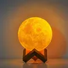 A moon-shaped lamp with a wooden stand. Podgląd zdjęcia produktu