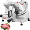 A commercial meat slicer with a blade, handle, and controls, shown from a front-diagonal angle. A small arrangement of sliced meat with parsley and olives is placed in the foreground. Podgląd zdjęcia produktu