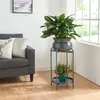 A plant stand with two plants in a living room setting. Podgląd zdjęcia produktu