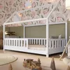 A child's bedroom with a house-shaped bed, toys, and floral wallpaper. Produktbild-Vorschau