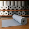Rolls of felt fabric are stacked on shelves, with one roll unrolled on a wooden surface in the foreground. Anteprima dell’immagine prodotto