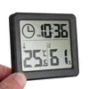 A hand holding a digital thermometer and hygrometer with a clock display. Anteprima dell’immagine prodotto