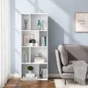 A white bookshelf filled with decorative items and books, placed next to a grey sofa in a room with light blue walls. Produktbild-Vorschau