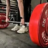 A person is performing a deadlift in a gym. Produktbild-Vorschau