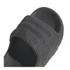 A close-up view of a dark gray Adidas Adilette 22 slide sandal. Podgląd zdjęcia produktu