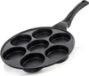 A black frying pan with seven circular indentations for cooking small items like pancakes or eggs. Náhled obrázku produktu