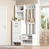 A white entryway organizer with shelves, drawers, hooks, and a bench, placed in a room next to a door and a window. Podgląd zdjęcia produktu