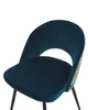 A close-up view of a modern dining chair with a blue velvet seat and back, featuring a cutout in the backrest and a floral pattern on the sides. Náhľad obrázku produktu