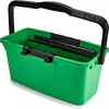 A green cleaning caddy with a black handle is shown against a white background. Voir les images du produit
