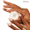 Hands with manicured nails holding a small jar of cosmetic product. Podgląd zdjęcia produktu
