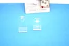 Two clear plastic window hooks are displayed on a blue background, with a product information card visible behind them. Produktbild-Vorschau