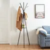 A coat rack with a coat and hat hanging on it, placed next to a sofa and a door. Produktbild-Vorschau