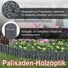 A garden border made of palisades with flowers and grass in the background, with rain falling. Voir les images du produit