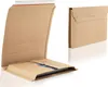 Two cardboard book packaging boxes are shown against a white background. One is open, revealing a flat item inside, and the other is closed. Produktbild-Vorschau