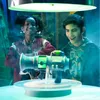 Two children are looking at a futuristic-looking device with green glowing parts. Náhled obrázku produktu
