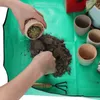 Hands are shown repotting a small cactus into a pot, with soil and other pots on a green mat. Produktbild-Vorschau