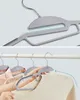 Two close-up images of grey plastic hangers designed for space-saving, with a detail shot showing the hanger's construction and a second shot demonstrating its use with clothing on a rack. Produktbild-Vorschau