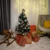 A decorated Christmas tree with gifts underneath, a rocking horse, and a chair in the background. Náhled obrázku produktu