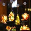 Christmas-themed window lights featuring Santa Claus, a snowman, a Christmas tree, and a sleigh with reindeer, illuminated and hanging in a window. Produktbild-Vorschau