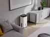 A modern living room with a dehumidifier next to a sofa and a cabinet. Podgląd zdjęcia produktu