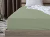 A close-up view of a light green fitted sheet on a bed. Anteprima dell’immagine prodotto