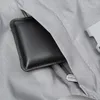 A close-up view of a black wallet inside a gray zippered pocket of a bag. Produktbild-Vorschau
