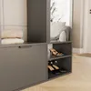 A modern wardrobe with folded towels and shoes on shelves. Voir les images du produit