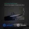 A modern bathroom scene with a large LED mirror reflecting a bathtub and sink. Produktbild-Vorschau