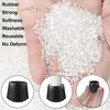 A hand holds a pile of clear plastic pellets, with text listing product features on the left and three circular insets showing black furniture leg caps. Produktbild-Vorschau