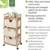 A wooden storage cart with three fabric drawers, shown with some bathroom accessories on top. Text describes features in English and German. Podgląd zdjęcia produktu