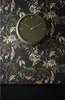 A green wall clock is mounted on a dark floral wallpaper. Anteprima dell’immagine prodotto