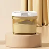 A food storage container filled with powder, placed on a pedestal against a backdrop of draped fabric. Produktbild-Vorschau