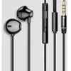 A close-up studio shot of a pair of black earphones and their accessories against a white background. Podgląd zdjęcia produktu