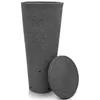 A tall, tapered, dark gray rain barrel with a textured surface and a separate round lid resting next to it. The barrel has small holes near the bottom. Produktbild-Vorschau