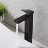 A dark bronze faucet with water running into a white sink. Náhľad obrázku produktu