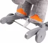 Close-up view of the feet and base of a stuffed elephant toy on a rocking mechanism. Voir les images du produit