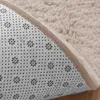 Close-up view of the underside and edge of a beige rug. Podgląd zdjęcia produktu