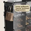 A close-up view of a black shoe rack with a brown tote bag and an umbrella hanging from hooks on the side. The rack has transparent doors for the shoe compartments. Podgląd zdjęcia produktu