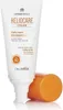 A tube of sunscreen with its cap off, resting on a reflective surface. Náhled obrázku produktu