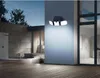 A solar-powered outdoor light fixture mounted on a wall, illuminating a patio area at dusk. Anteprima dell’immagine prodotto