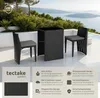A rattan garden furniture set with two chairs and a table on a patio overlooking a body of water. Náhled obrázku produktu