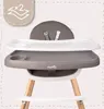 A close-up view of a baby high chair with a tray and seat. Voir les images du produit