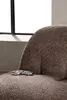 A close-up shot of a brown textured armchair with a pair of glasses resting on the seat. A window is visible in the background. Podgląd zdjęcia produktu