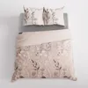 A bedding set with a floral pattern is laid out on a bed. Produktbild-Vorschau