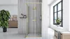 A modern bathroom with a gold-framed shower cabin, a large window, and decorative elements. Produktbild-Vorschau